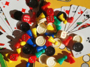 Tanya Pobuda Takes a Look at Board Game Diversity in New Presentation A bunch of board games components, such as pawns, cards, and more.