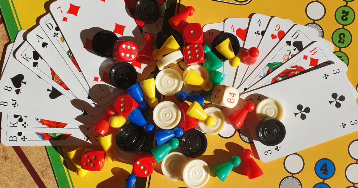 A bunch of board games components, such as pawns, cards, and more.
