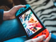 Gloomhaven for Nintendo Switch Arrives on September 18 A person holding and playing at a Nintendo Switch.