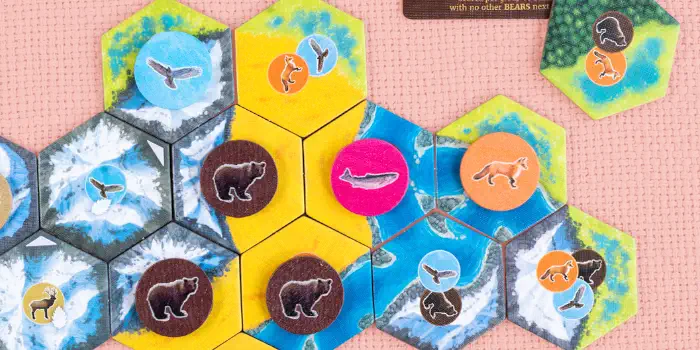 Tile pieces and animal tokens in Cascadia, the board game.